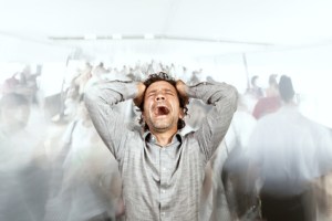 stressed man and lots of walking people